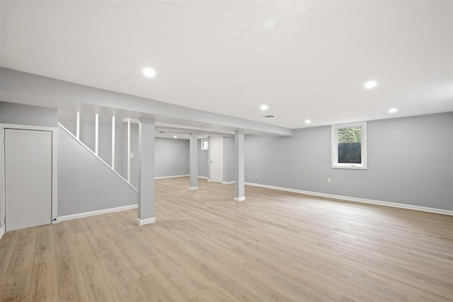 basement with light hardwood / wood-style floors