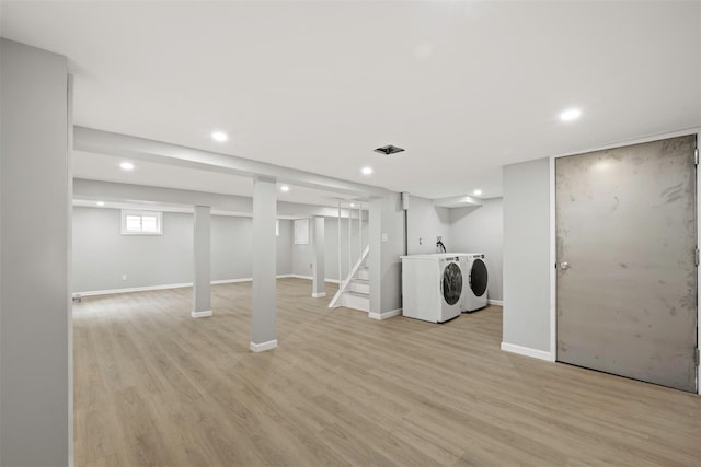 basement with independent washer and dryer and light wood-type flooring