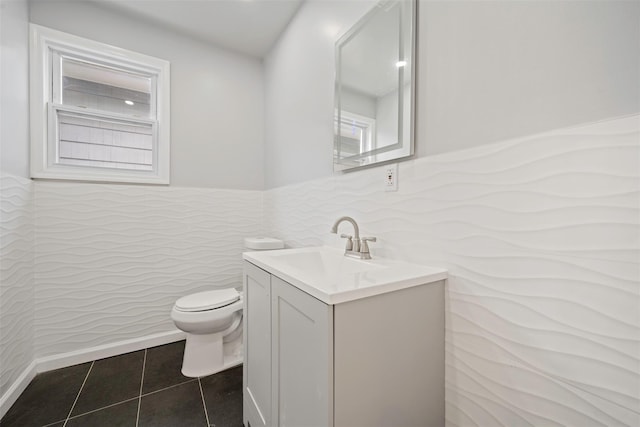 bathroom featuring tile patterned flooring, vanity, plenty of natural light, and toilet