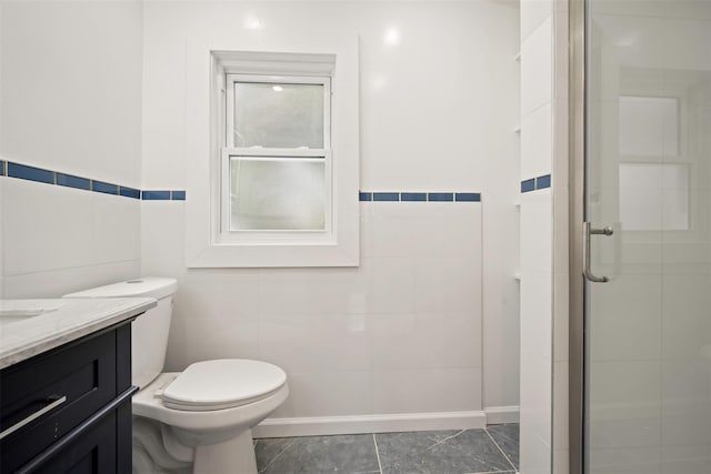 bathroom featuring tile walls, vanity, toilet, and walk in shower