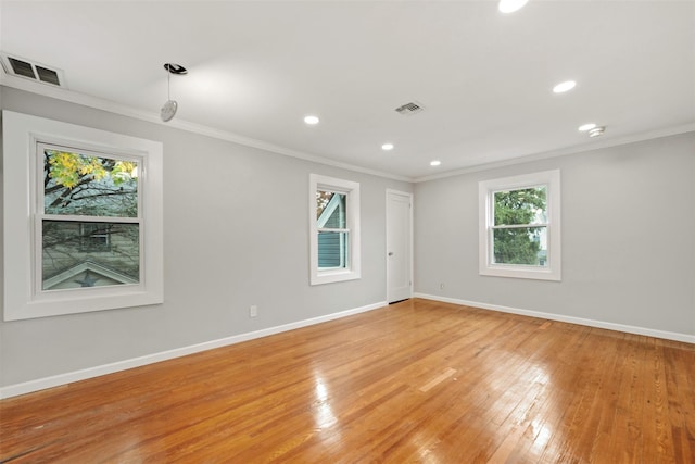 unfurnished room featuring crown molding and light hardwood / wood-style flooring