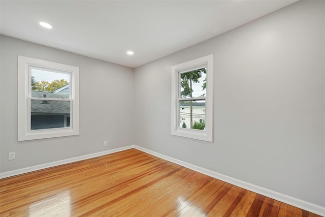 empty room with hardwood / wood-style flooring