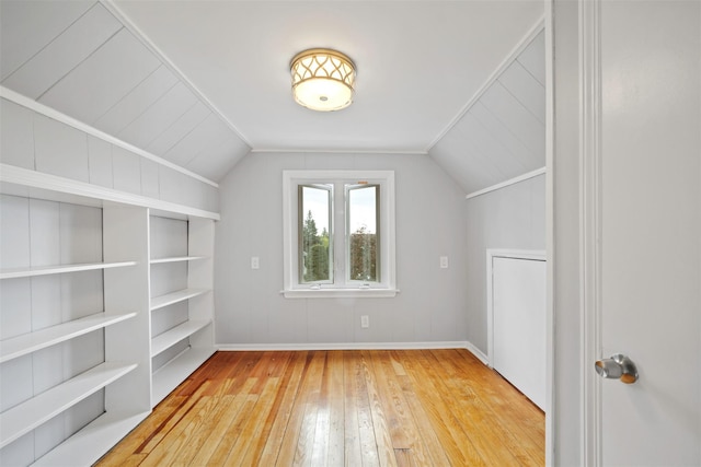 bonus room with vaulted ceiling and light wood-type flooring