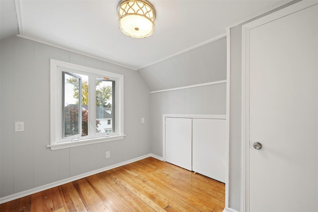 additional living space with lofted ceiling and hardwood / wood-style flooring