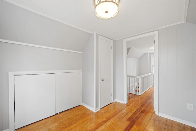 additional living space featuring wood-type flooring and vaulted ceiling