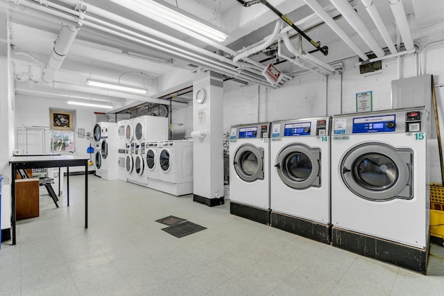 washroom with washing machine and clothes dryer and stacked washing maching and dryer