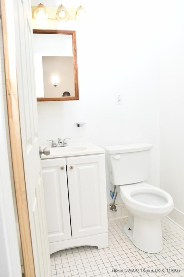 bathroom with vanity, tile patterned floors, and toilet