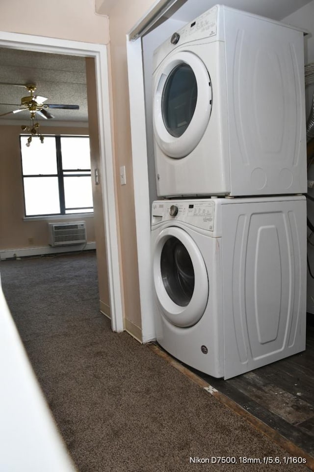 clothes washing area with stacked washer / drying machine, dark carpet, a wall mounted AC, and ceiling fan