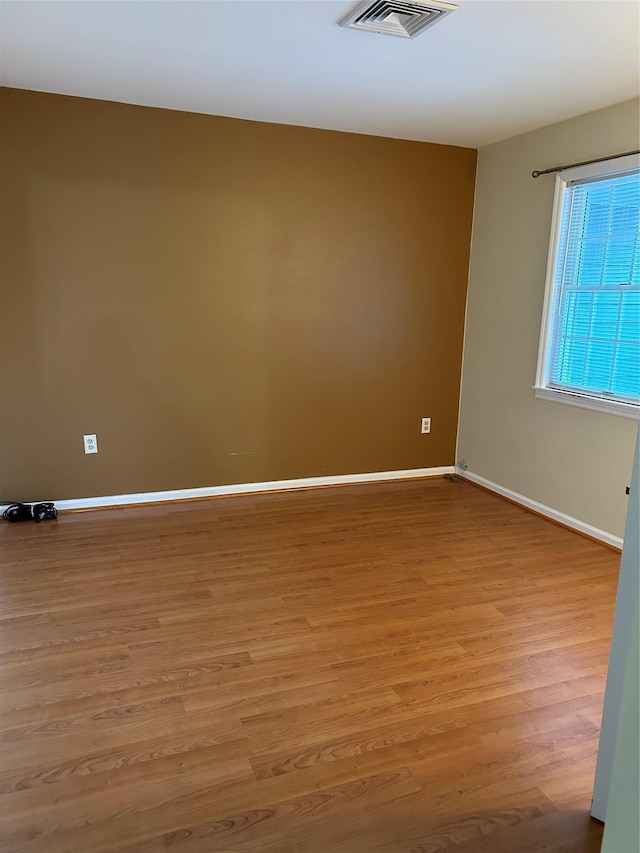 spare room featuring light hardwood / wood-style flooring