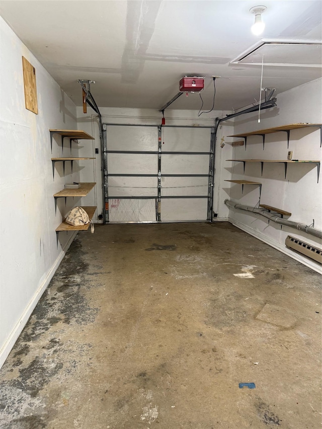 garage featuring a garage door opener and baseboards