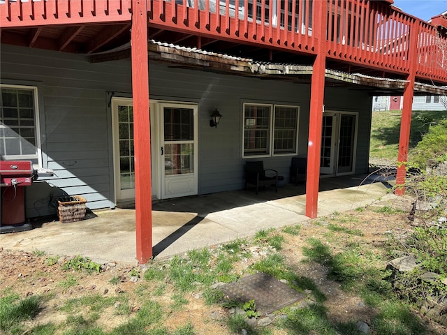 rear view of house with a deck and a patio