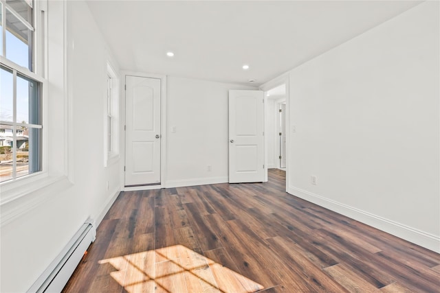 unfurnished bedroom with dark wood-style floors, recessed lighting, baseboards, and baseboard heating