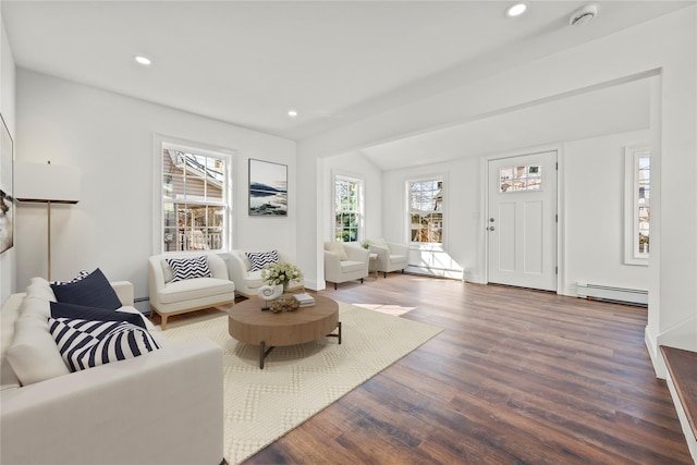 living room featuring a baseboard heating unit, wood finished floors, lofted ceiling, and recessed lighting