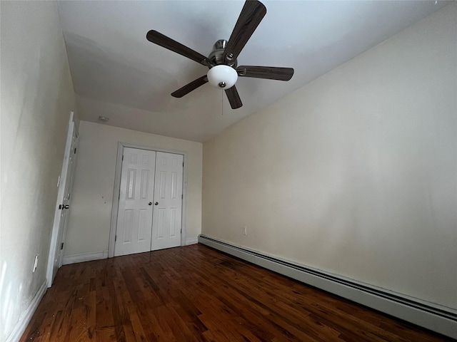 unfurnished bedroom featuring ceiling fan, hardwood / wood-style floors, a closet, and a baseboard heating unit