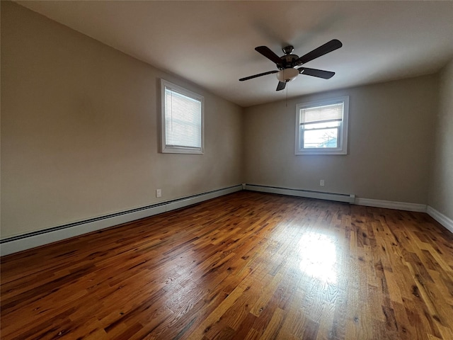 spare room with wood-type flooring, ceiling fan, and baseboard heating