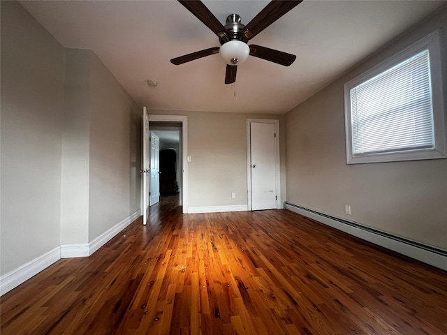 unfurnished bedroom with ceiling fan, a baseboard radiator, and dark hardwood / wood-style floors