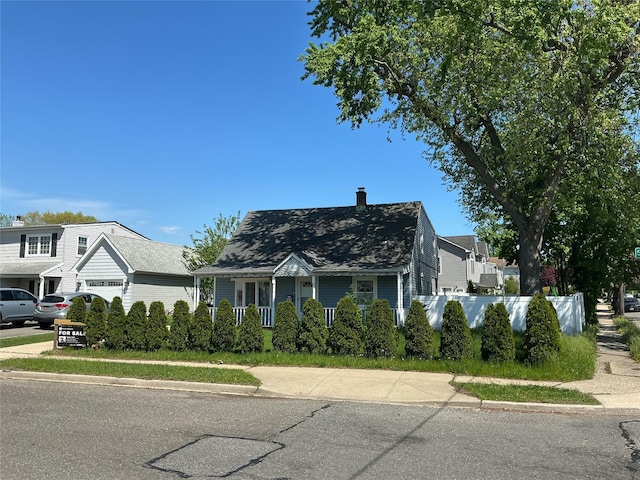 159 Spring Ln, Levittown, NY 11756 - view of front of home featuring a chimney, fence, covered porch, and a garage
