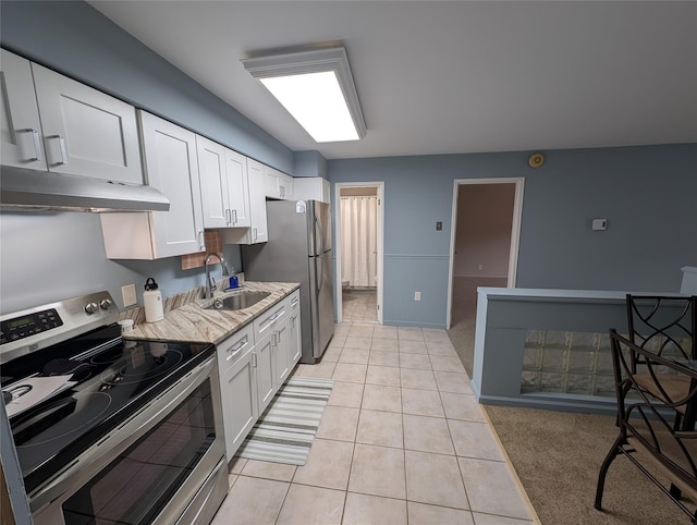 kitchen featuring white cabinetry, sink, light tile patterned floors, and stainless steel appliances