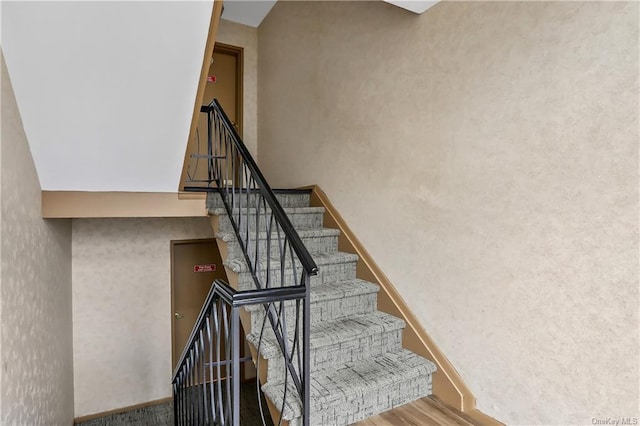 stairway featuring hardwood / wood-style flooring