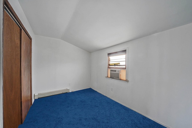 empty room with cooling unit, lofted ceiling, carpet flooring, and a baseboard heating unit