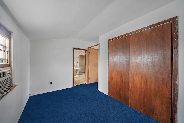 unfurnished bedroom with carpet floors, vaulted ceiling, and a closet