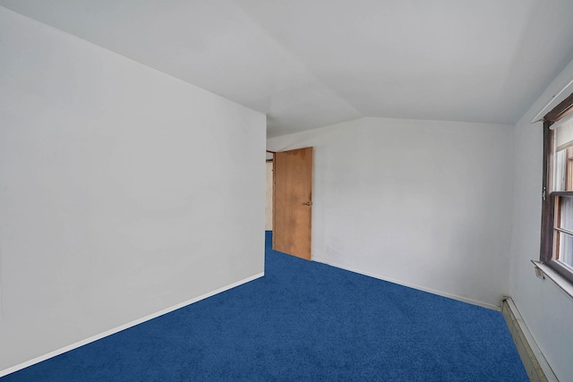 spare room featuring a baseboard radiator, carpet floors, and vaulted ceiling