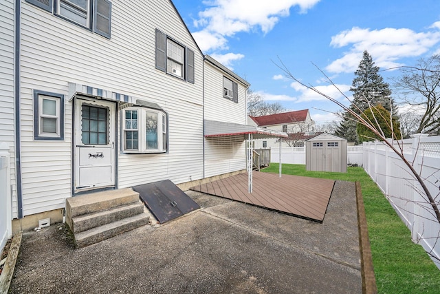 view of patio featuring a shed and a deck