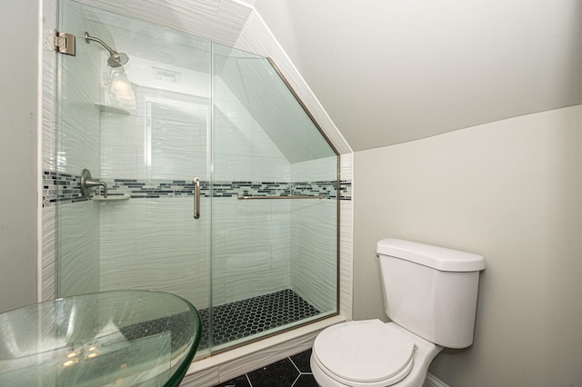 bathroom featuring walk in shower, vaulted ceiling, tile patterned floors, and toilet