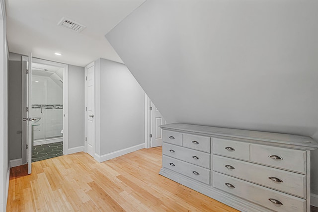 bonus room with light wood-type flooring