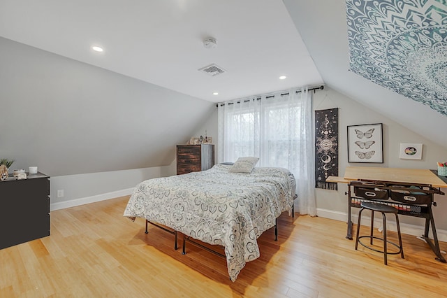 bedroom with hardwood / wood-style floors and vaulted ceiling