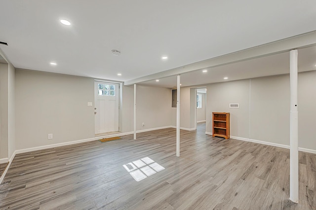 basement with light hardwood / wood-style flooring