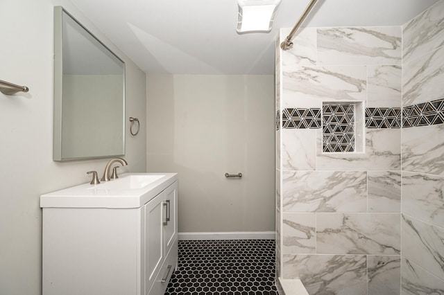 bathroom featuring vanity and tiled shower