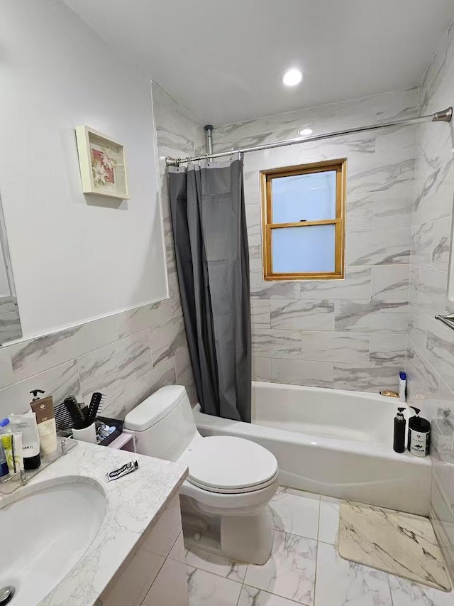 full bathroom with vanity, toilet, shower / tub combo, and tile walls