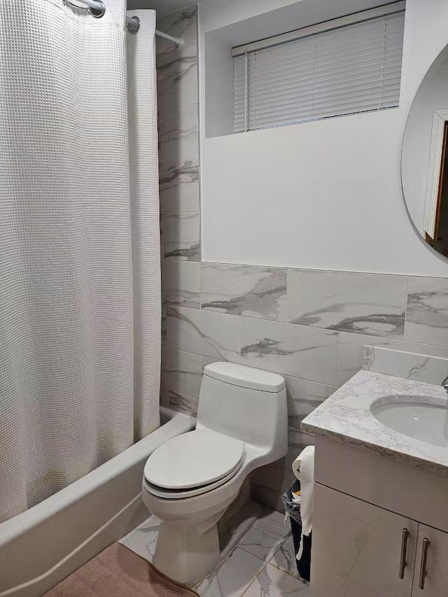 full bathroom with vanity, tile walls, shower / bath combination with curtain, and toilet