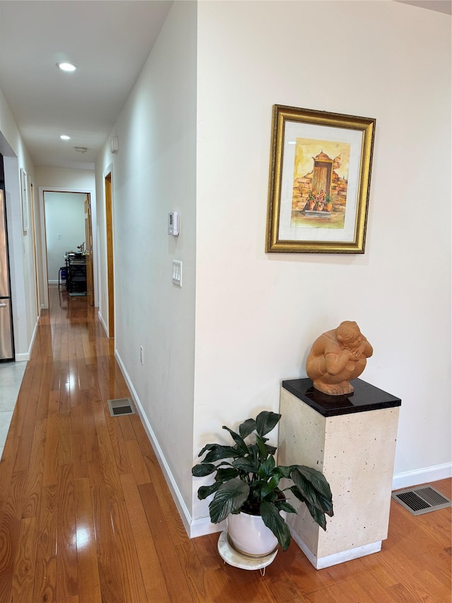 hall with hardwood / wood-style floors