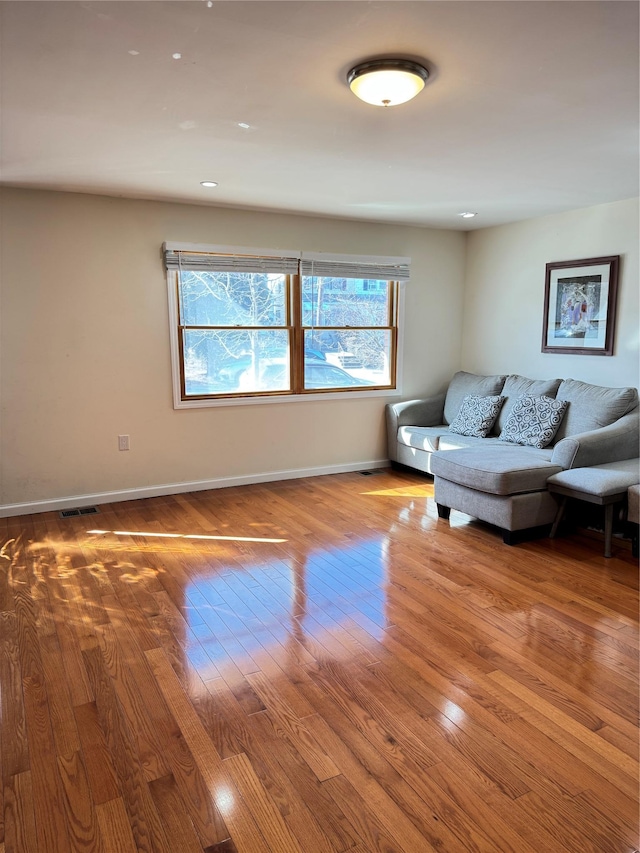 unfurnished living room featuring wood-type flooring