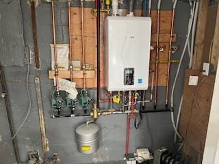 utility room featuring tankless water heater