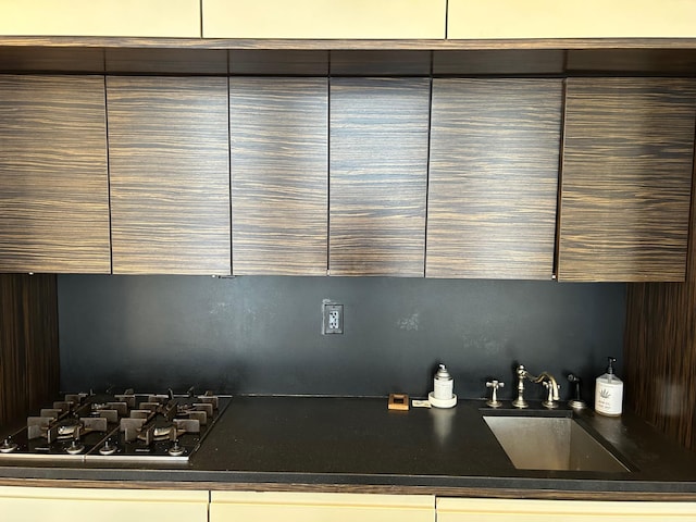 bar featuring sink and gas cooktop