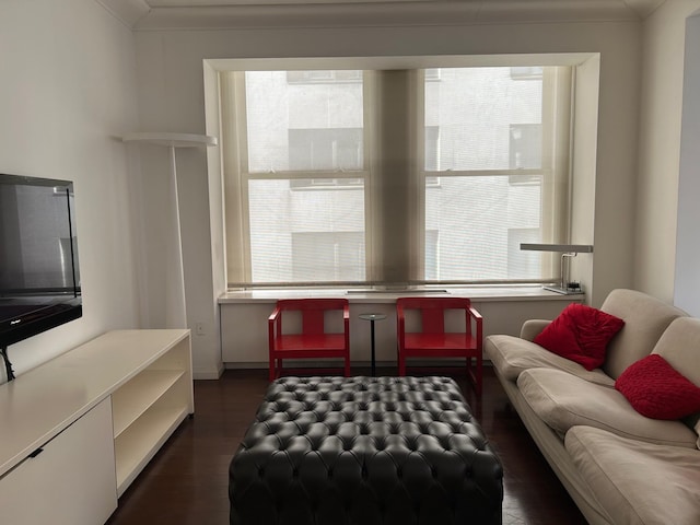 living room featuring ornamental molding and dark hardwood / wood-style flooring