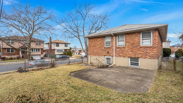 back of house with a yard and a patio area