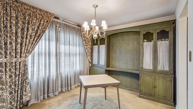 office featuring light carpet and a notable chandelier