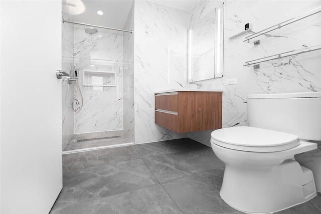 bathroom featuring vanity, toilet, and a tile shower