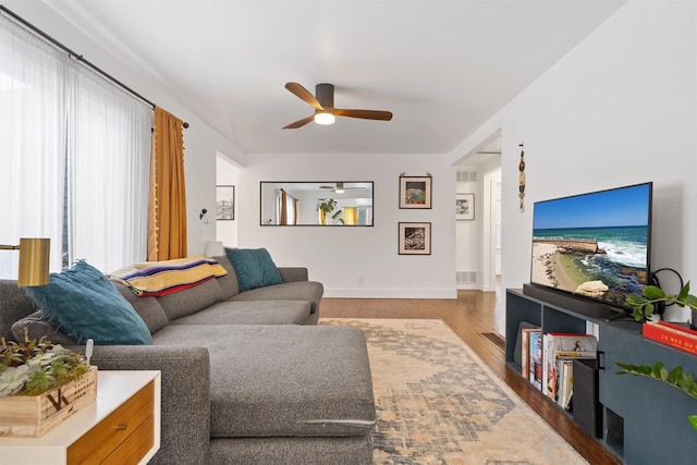 living room with hardwood / wood-style floors and ceiling fan