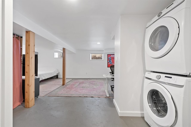 washroom featuring stacked washer / drying machine