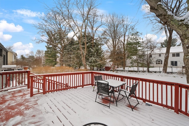 snow covered deck featuring a grill