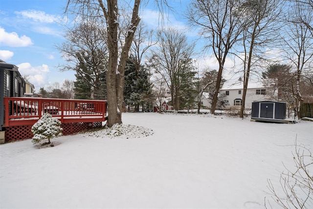 yard covered in snow with a deck