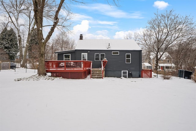 snow covered property with a wooden deck