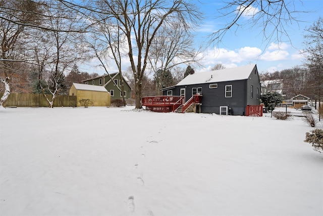 yard covered in snow featuring a wooden deck