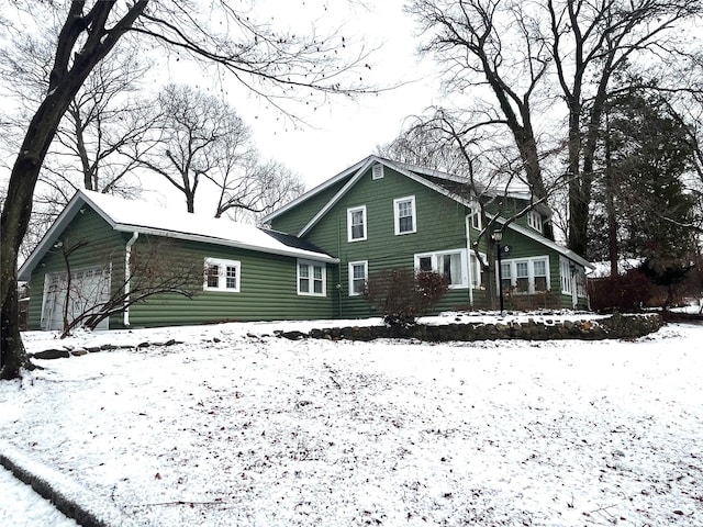 view of snow covered rear of property