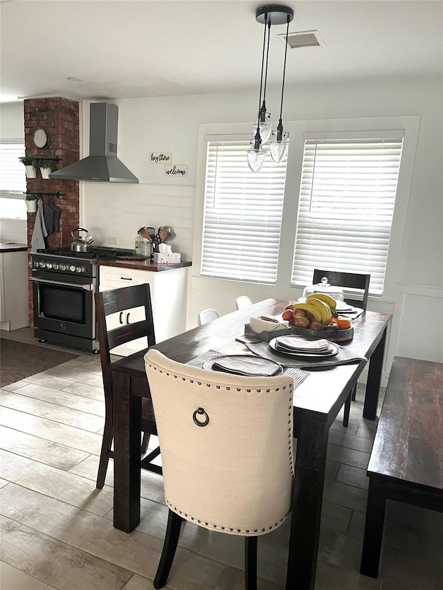 dining space featuring plenty of natural light and light hardwood / wood-style floors